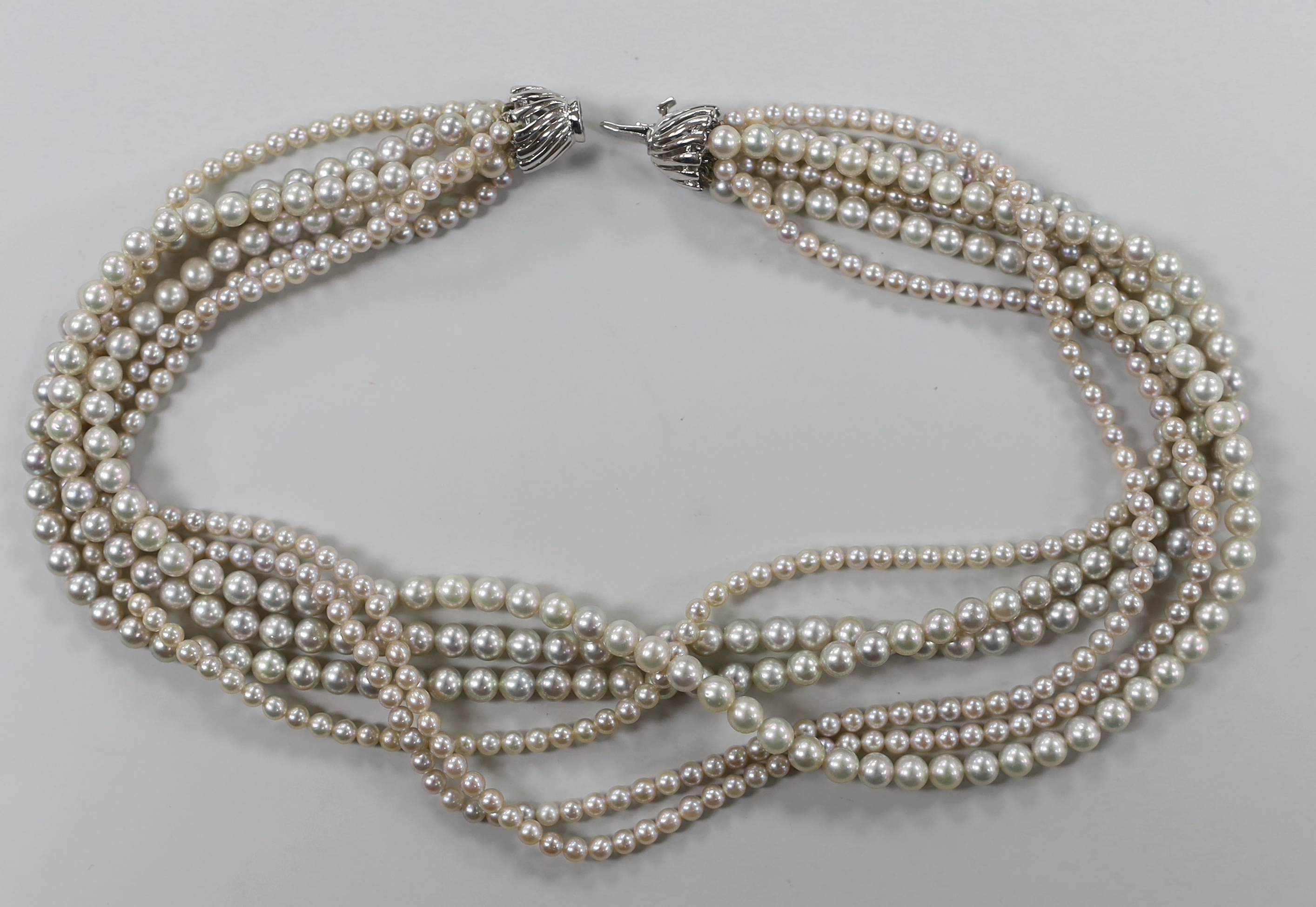 A modern multi-strand graduated cultured pearl choker necklace, with 9ct white metal clasp, 36cm.